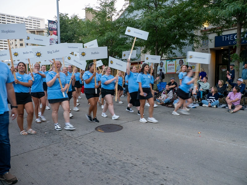 Community event volunteers holding signs