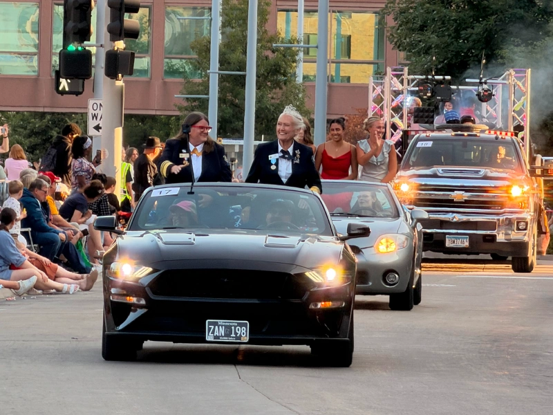 Community parade with convertible car