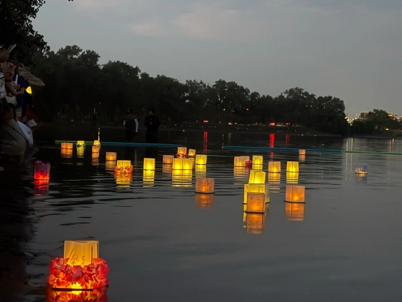 Community floating lanterns event at dusk